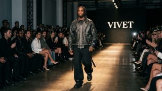 Model walking the runway wearing Kai Cenat's VIVET distressed leather jacket at NYFW